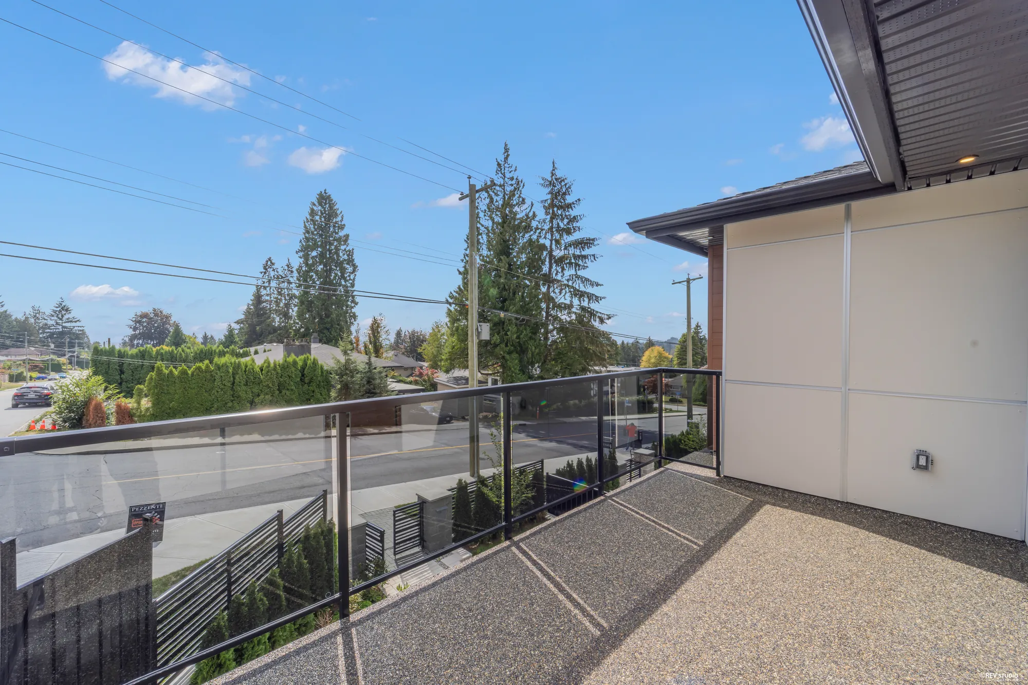 The front balcony toward the neighbours, the wall of the house on the right