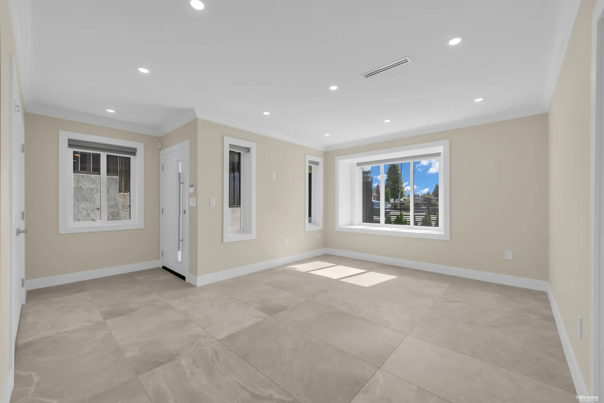 The main-floor bedroom: two windows, a door, tiled floor