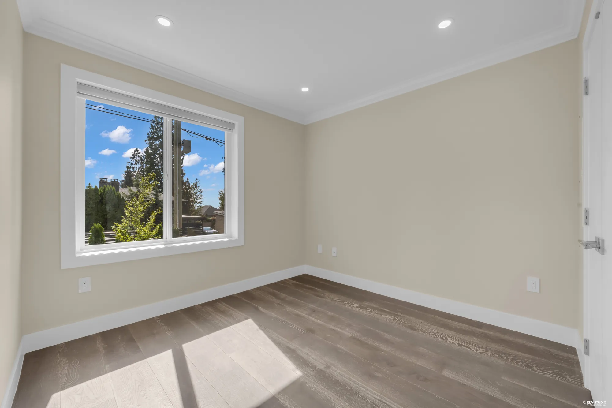The main-floor bedroom's window onto the street and the trees