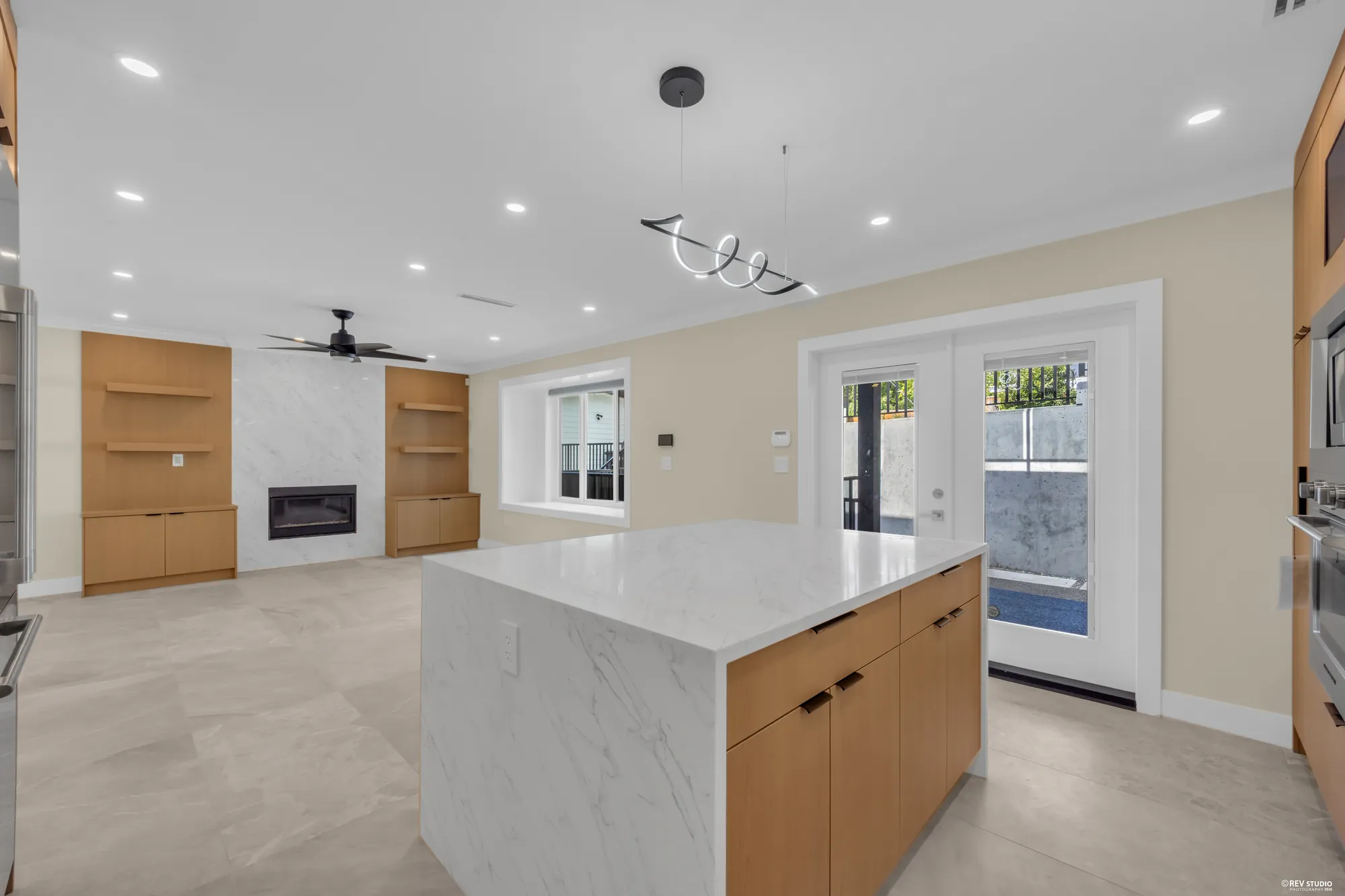The kitchen and the fireplace wall in one frame, the deck doors on the right