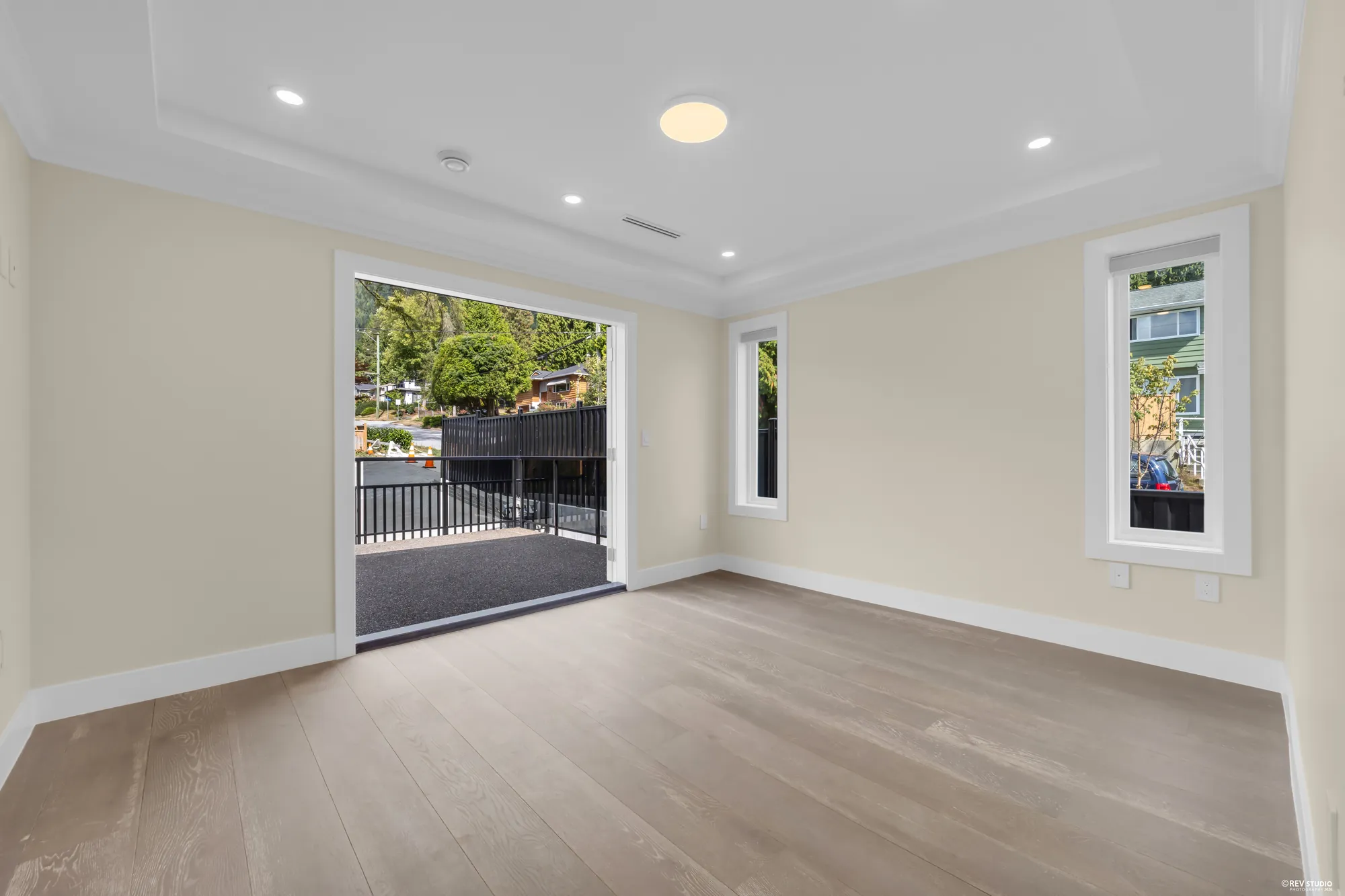 The primary bedroom from the balcony doors