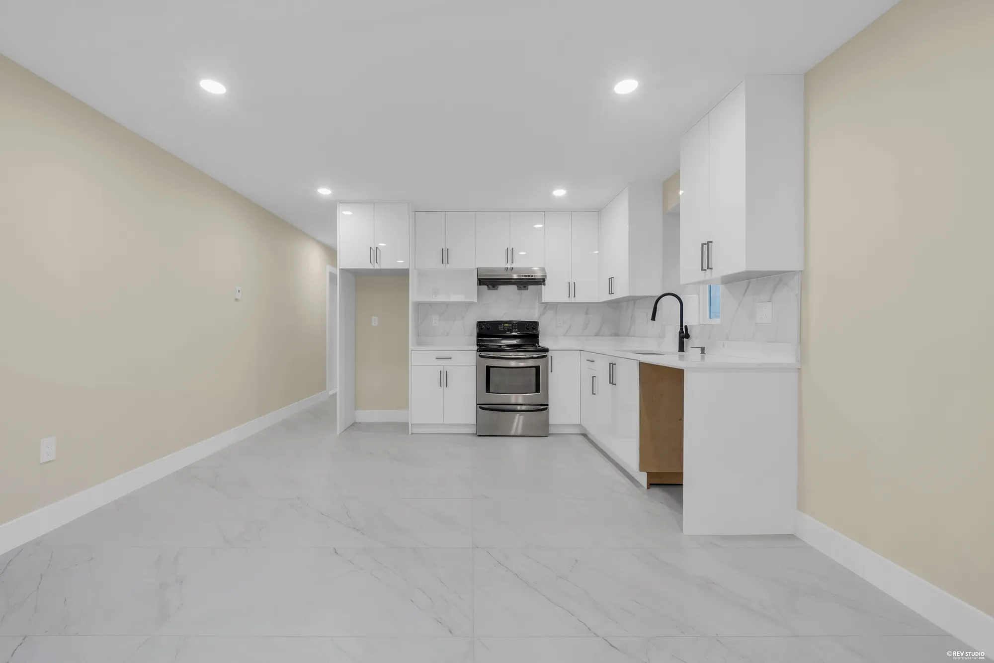 The lower kitchen's range and counter under the window